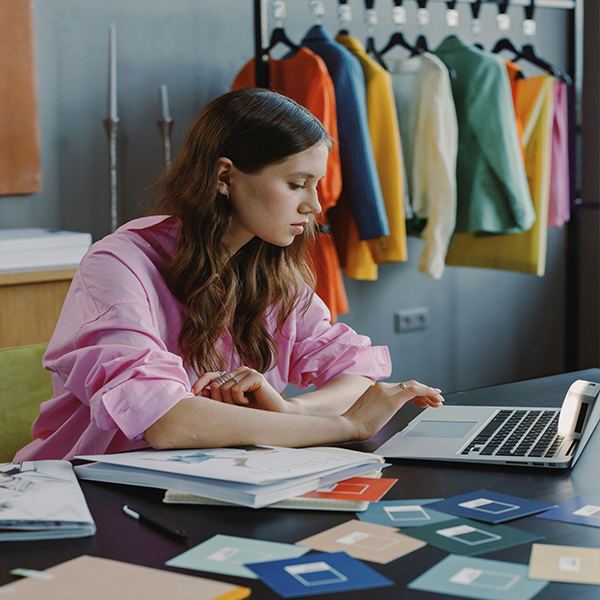 Canadian Small Business Clothing Store Owner Reviewing Job Applications Online